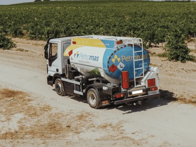 Camión cisterna rotulado entre viñedos